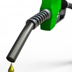 Green fuel nozzle with golden droplet on white background